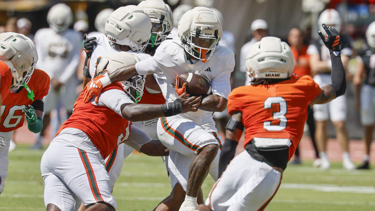 Miami Hurricanes running back Jordan Lyle (2) on a carry as Miami Hurricanes defensive lineman Justin Scott (5) and defensive lineman Bryce Fitzgerald (3) defend during UM’s spring football game at Cobb Stadium on the University of Miami campus in Coral Gables, Florida, on Saturday, April 18, 2026. Miami Hurricanes running back Jordan Lyle (2) on a carry as Miami Hurricanes defensive lineman Justin Scott (5) and defensive lineman Bryce Fitzgerald (3) defend during UM’s spring football game at Cobb Stadium on the University of Miami campus in Coral Gables, Florida, on Saturday, April 18, 2026.